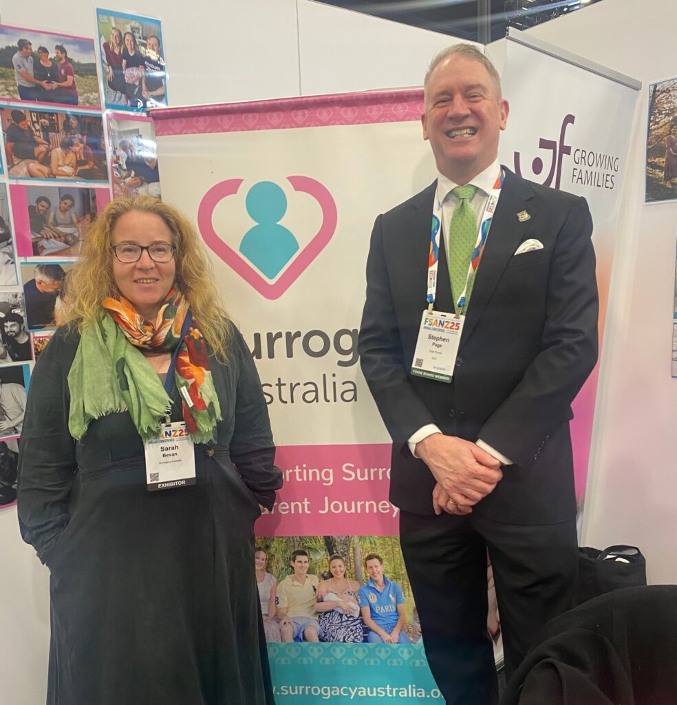 Stephen Page with Sarah Bevan in front of the Surrogacy Australia stall at the FSANZ Conference 2025